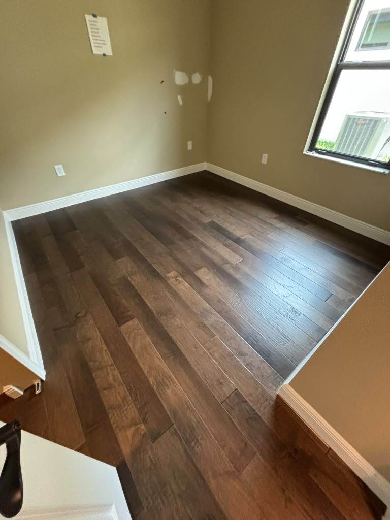 Hardwood flooring leading through French doors